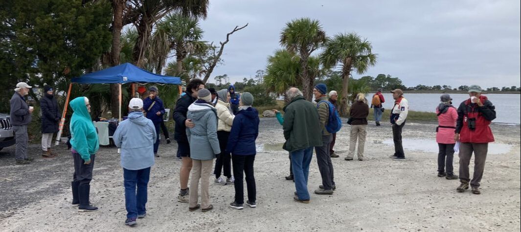 Picture of visitors enjoying Hot tea, cookies, and socializing after the guided walks and before the talk on the pier