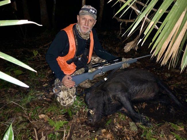 Picture of hunter with downed feral hog