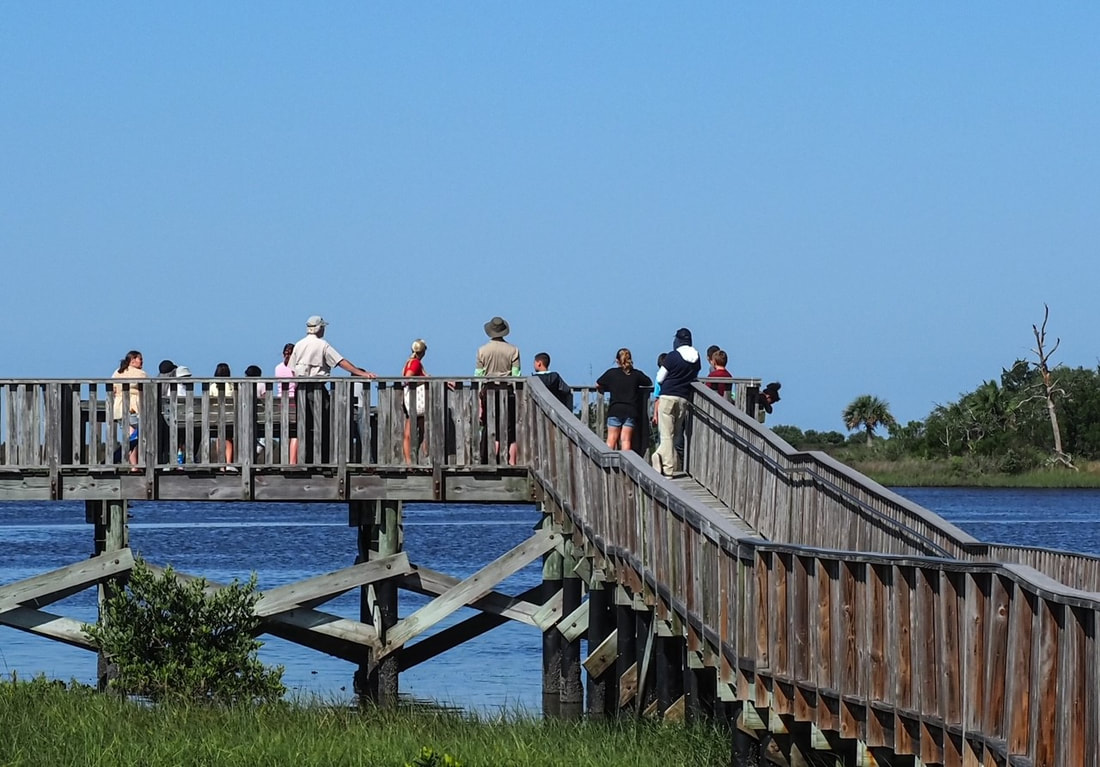 Picture of A group of the students and volunteers at the Clean Water Matters Station on the fishing pier