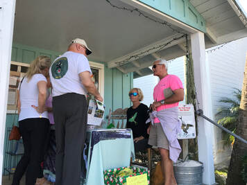  Picture of Friends board member Denise Feiber  and Refuge Manager Andrew Gude welcoming visitors in Cedar Key