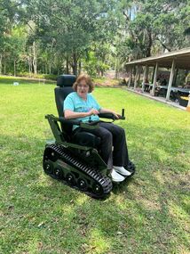 Picture of a woman driving an EcoRover in a city park on grass