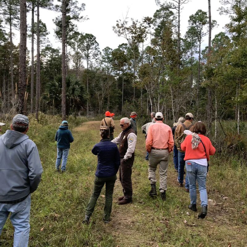 Picture of the Refuge Manager talking to a group on a native plant walk