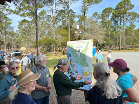Picture of visitors and members at the Refuge map at Annual Meeting 2023