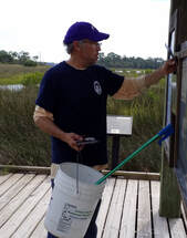 Picture of Mike Caulking cleaning the gazebo