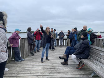 Picture of Friends' president Dr. Ginessa Mahar and other participants on the Shell Mound pier for Winter Solstice 2022