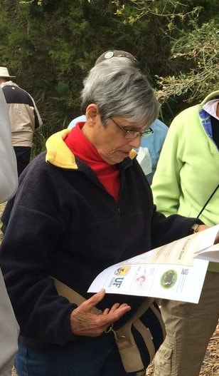 Picture of Jeri reading an informational brochure at Shell Mound