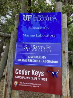 Picture of Signs for the Cedar Keys NWR and both Univ of FL and Santa Fe College who use the Refuge for education and research