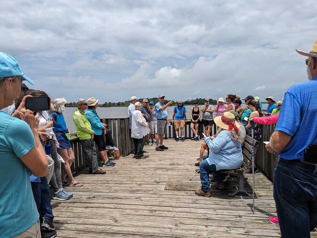 Picture of Dr. Sassaman and the participants on the pier.